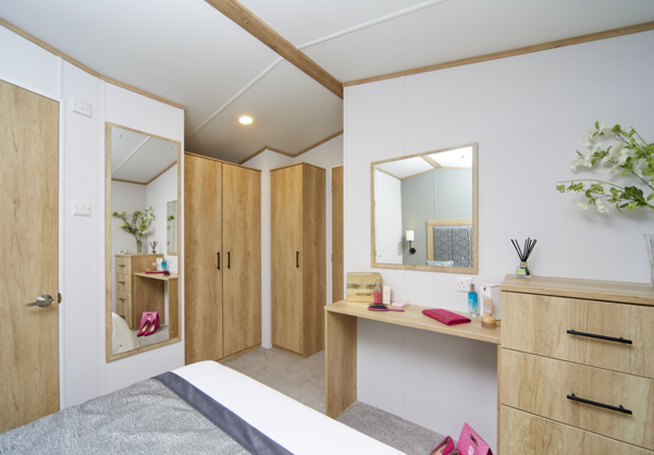 Internal of a caravan master bedroom with dressing area