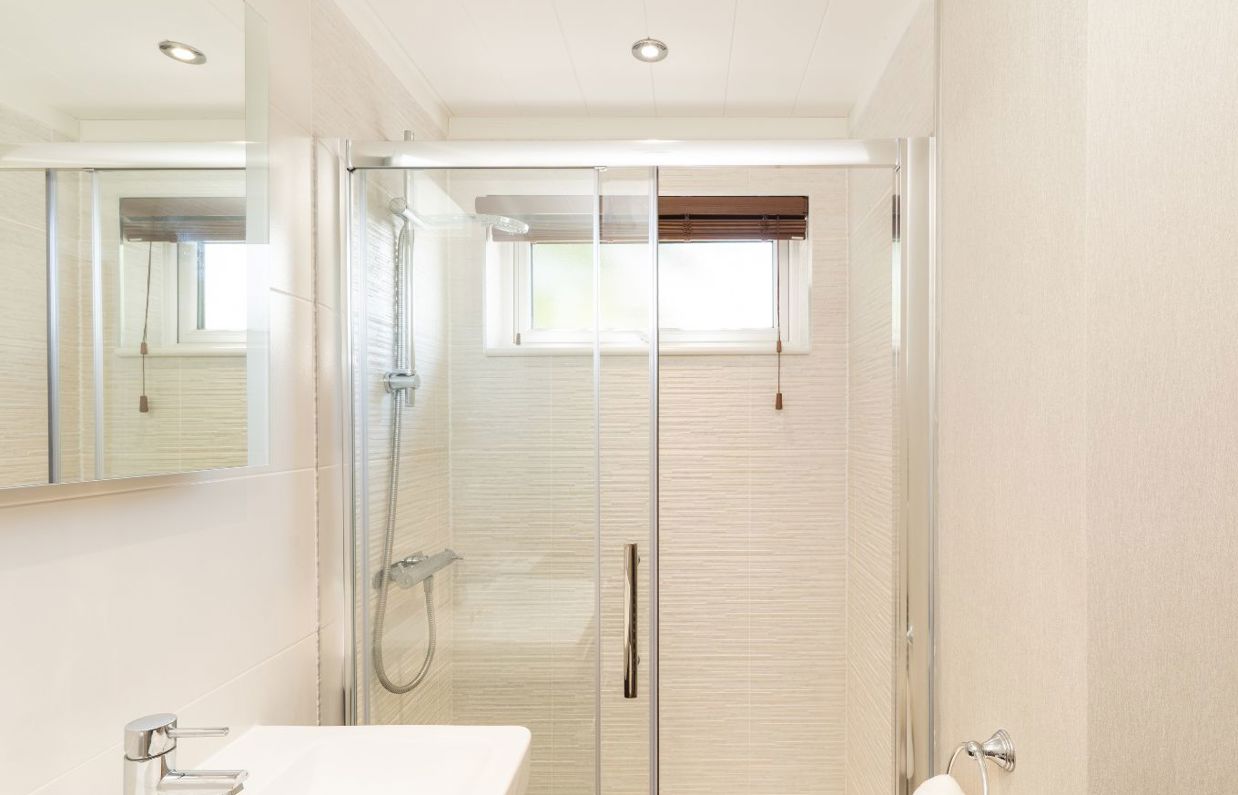 Internal of a lodge ensuite bathroom with shower and sink