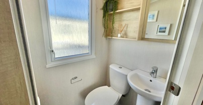 Internal of a caravan ensuite bathroom with toilet and sink