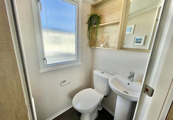 Internal of a caravan ensuite bathroom with toilet and sink