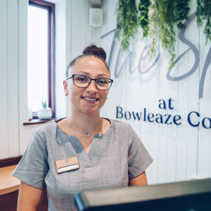 A lady at the reception of The Spa at Bowleaze Cove