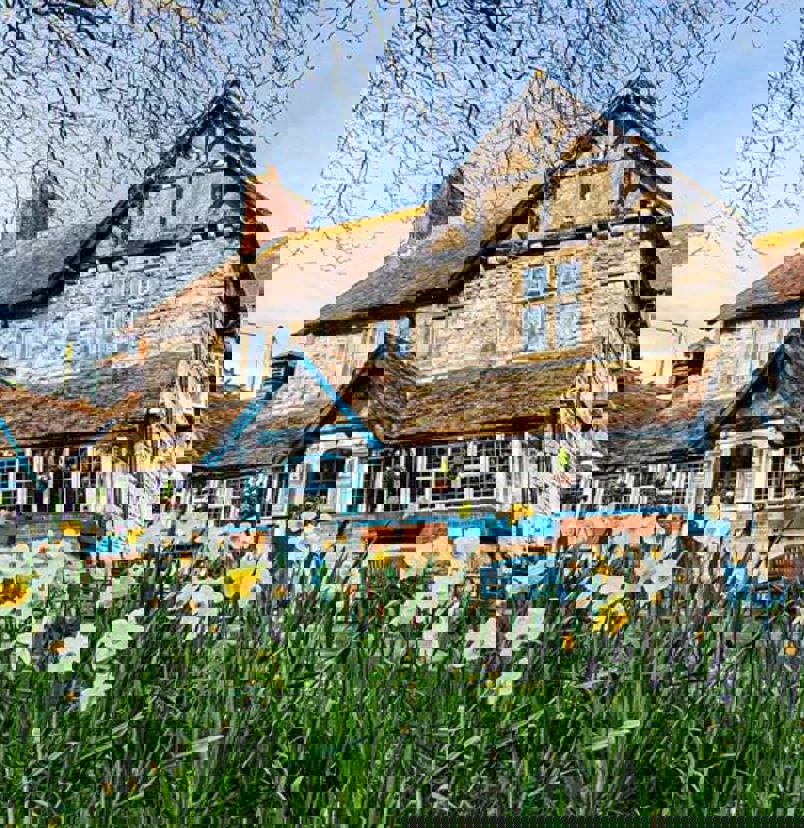 A quaint cottage-style pub among woodland and flowers