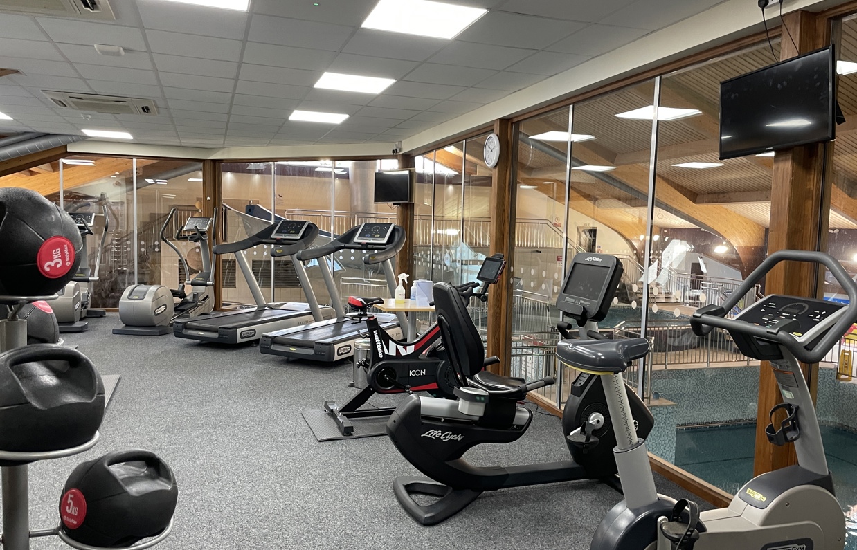Internal of an indoor gym with various cardio and weight lifting equipment
